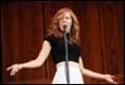 A person singing into a microphone

Description automatically generated
