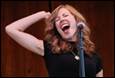 A person singing into a microphone

Description automatically generated