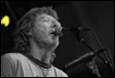 A person singing into a microphone

Description automatically generated