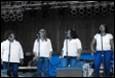 A group of people singing on stage

Description automatically generated