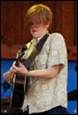 A person playing a guitar

Description automatically generated