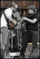 A group of people playing instruments

Description automatically generated