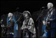 A group of people singing on stage

Description automatically generated