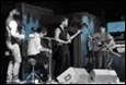 A group of people playing instruments

Description automatically generated