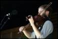 A person playing a violin

Description automatically generated