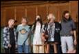 A group of people singing into microphones

Description automatically generated