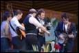 A group of men playing instruments

Description automatically generated