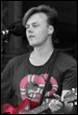 A person with a guitar

Description automatically generated