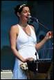 A person singing into a microphone

Description automatically generated