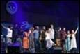 A group of people on a stage

Description automatically generated