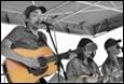 A group of people playing guitars

Description automatically generated