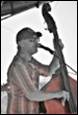 A person playing a bass

Description automatically generated