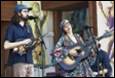 A group of people playing instruments

Description automatically generated