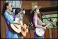 A group of people playing instruments

Description automatically generated