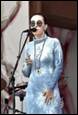 A person wearing a blue dress and sunglasses

Description automatically generated