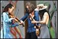 A group of people playing instruments

Description automatically generated