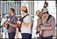 A group of men playing instruments

Description automatically generated