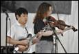 A group of people playing instruments

Description automatically generated