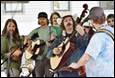 A group of people playing instruments

Description automatically generated