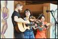 A group of people playing instruments

Description automatically generated