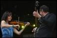 A person and person playing instruments

Description automatically generated