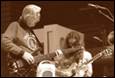 A group of people playing guitars

Description automatically generated