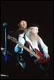 A person with a long beard playing a guitar

Description automatically generated