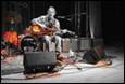 A person playing a guitar on stage

Description automatically generated with medium confidence