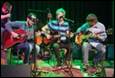 A group of men playing guitars

Description automatically generated