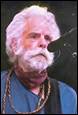 A person with a white beard and mustache speaking into a microphone

Description automatically generated with medium confidence