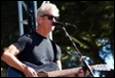 A person playing guitar and singing into a microphone

Description automatically generated with low confidence