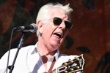 A person with sunglasses and a guitar

Description automatically generated with low confidence