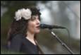 A person singing into a microphone

Description automatically generated