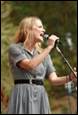 A person singing into a microphone

Description automatically generated