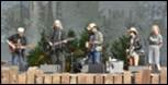 A group of men playing instruments

Description automatically generated