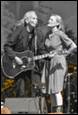 A person and person playing guitar

Description automatically generated