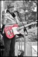A person holding a guitar

Description automatically generated