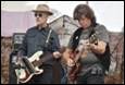 A group of men playing guitars

Description automatically generated