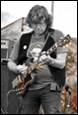 A person playing a guitar

Description automatically generated