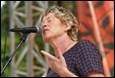 A person singing into a microphone

Description automatically generated