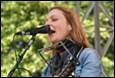 A person singing into a microphone

Description automatically generated