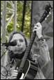 A person playing a guitar

Description automatically generated