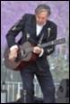 A person playing a guitar

Description automatically generated