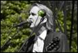A person singing into a microphone

Description automatically generated