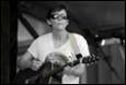 A person wearing sunglasses and playing a guitar

Description automatically generated with low confidence