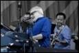 A group of men playing instruments

Description automatically generated with medium confidence