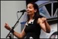 A person singing into a microphone

Description automatically generated