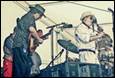 A group of people playing instruments

Description automatically generated with medium confidence