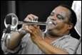 A person playing a trumpet

Description automatically generated