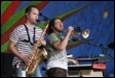 A couple of men playing instruments

Description automatically generated with low confidence